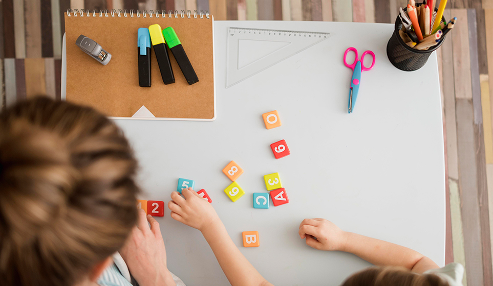 top-view-child-tutor-learning-about-numbers-letters